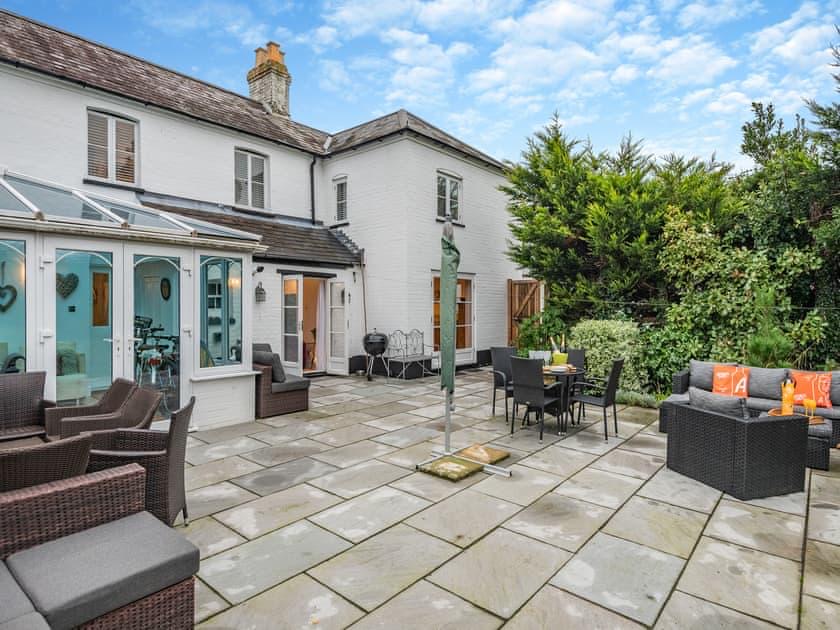 The rear of Victoria Cottage with the conservatory and garden patio