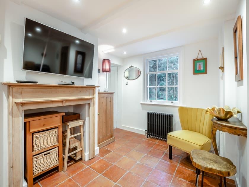 Second sitting room with a fireplace, wall-mounted television and armchair