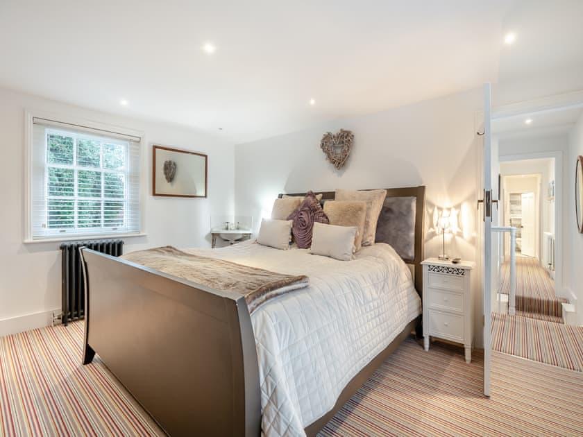 Bedroom three, with a wooden sleigh bed and antique wardrobe