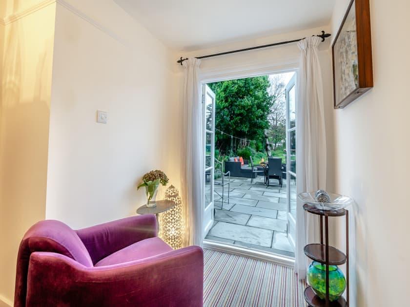 A quiet reading corner beside French doors leading to the garden